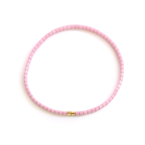 Hier siehst du ein rosa farbenes Armband aus Perlen mit 2 Goldperlen unten